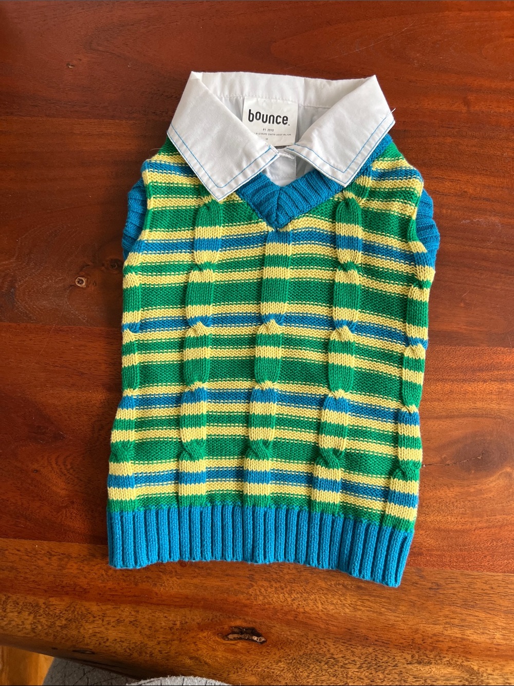 Cable knit, dog sweater vest with attached collar.